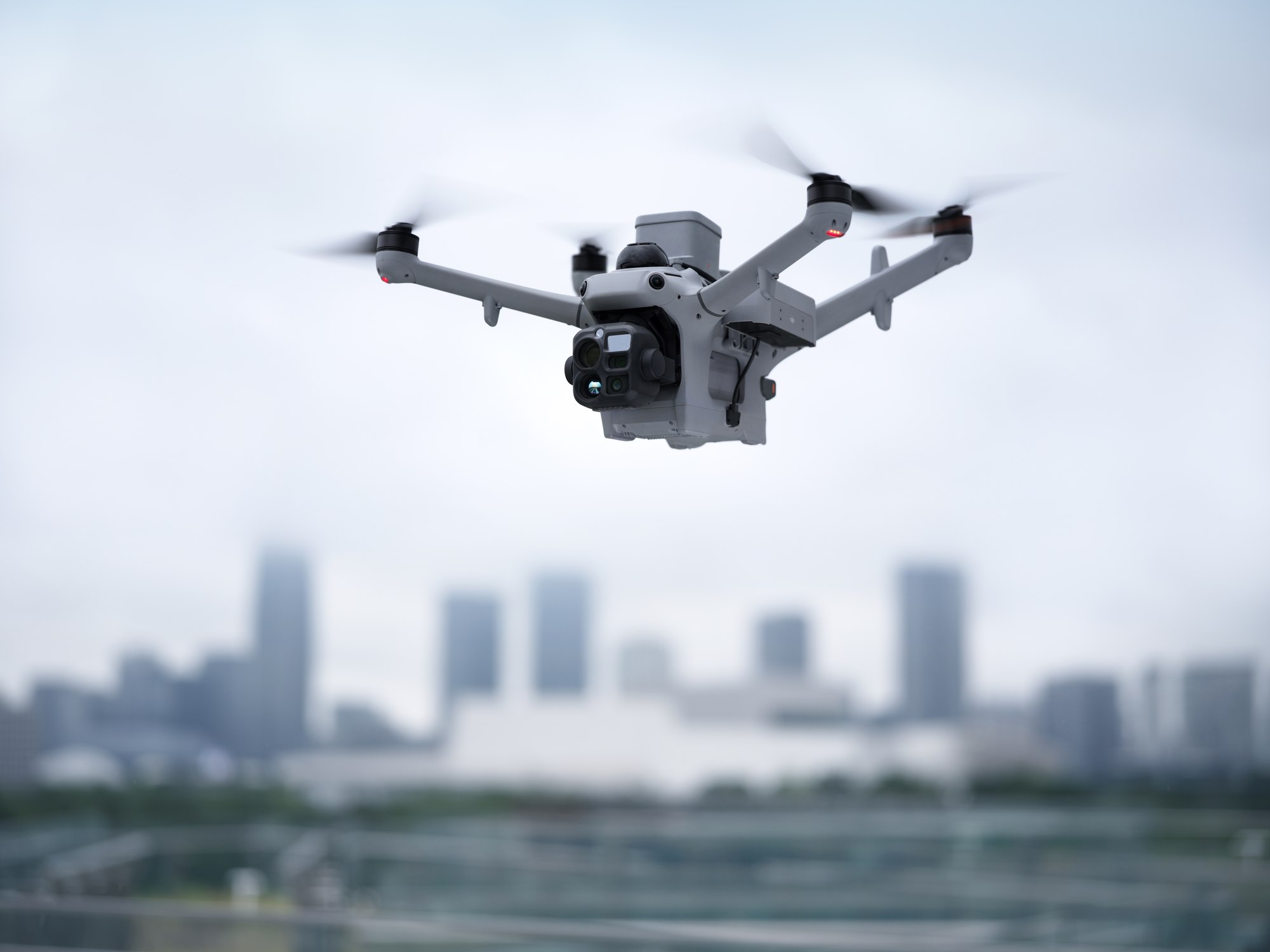 DJI Matrice 5TD mit Lautsprecher und Scheinwerfer im städtischen Umfeld bei Tag